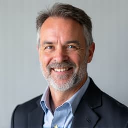 Jeremy Barr smiling holding a piece of wood