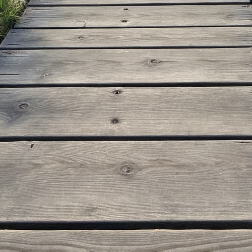 Weathered deck before professional restoration in Chelsea, AL.
