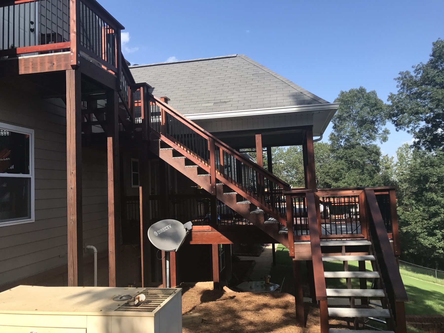 Close-up of a freshly stained and sealed wooden deck with a warm honey-colored finish.